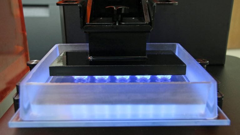 The new M-Type material tray from EnvisionTEC’s Micro and Vida desktop 3D printers lasts 3-4 months, costs under $200 and is disposable. The bottom is optical glass coated in a film that allows for easy separation of exposure layers, surrounded a soft but firm silicone frame.